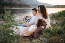 In Washington, USA, a mom and her teenage kids sit by the river, enjoying quality time together.