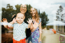 Family Gathered in Festive Unity by the Glass Window in Carp, Ontario, Canada In Carp, Ontario, Canada, family members gather in front of a glass window during a festive family party.