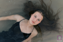 Top-Down Portrait of a Woman Floating Peacefully in Port Washington, Wisconsin A dramatic portrait of a woman floating on her back in the shallow water of Port Washington, Wisconsin. The photo is a top-down view, with her hair flowing in the water.