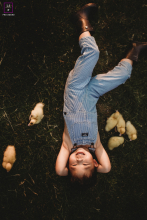 A Cherished Farewell: Boy and Duck Friends in Oakville In Oakville, ON, a young boy holds his cherished duck friends close, reluctant to say goodbye. He poses for one last photo with them, capturing a bittersweet farewell to a treasured friendship.