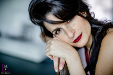 Cologne Contemplation: A Young Woman's Gentle Reflection Close-up portrait of a young woman in Köln, Germany. She rests her hands on the back of a chair, gently leaning her face on her hands, with a calm and thoughtful expression.