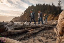 Coastal Family Walk On Driftwood At Cannon Beach, Oregon, a family walks together on a driftwood log by the ocean, capturing a scene on the scenic Oregon Coast.
