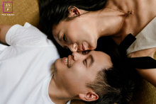 In Toronto, a couple celebrates their seventh anniversary in a yin-yang pose; she kisses him, both cherishing each other as the greatest gift.