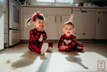 Boston Siblings Play with Shadows in Red and Black Buffalo Plaid Pajamas Boston lifestyle portrait showing shadow play with two siblings in buffalo red and black plaid pajamas.