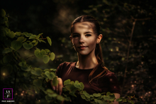 In Blackpool, Stella emerges from the darkness with dramatic light sculpting her face against the woodland backdrop. The rich shadows and glowing highlights give the photograph mystery, elegance, and the atmosphere of a modern fairy tale.