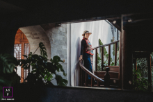 Framed through the dark interior in Yunnan, this quiet figure pauses on the staircase with calm confidence and mystery. The layered composition, soft window light, and surrounding shadows give the photograph depth, elegance, and cinematic restraint.