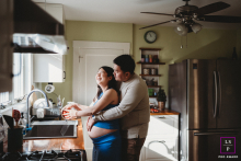 Couple Shares Personal Kitchen Embrace Before Parenthood in Honestly Lit Afternoon Boston, Massachusetts Portrait In a Boston kitchen, a quiet embrace turns an ordinary afternoon into something deeply personal as the couple pauses together before parenthood arrives. The natural window light and everyday setting make the photograph feel honest and beautifully grounded