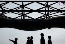 This Paris family appears in silhouette beneath a striking geometric canopy, each figure separated by posture and gesture. The child pointing adds curiosity and direction, while the minimalist composition transforms an ordinary walk into something graphic