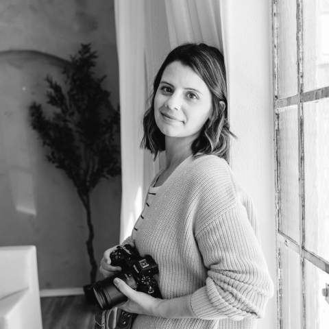 Portrait of Elise Souders, Bend, Oregon Photographer holding a Nikon Camera